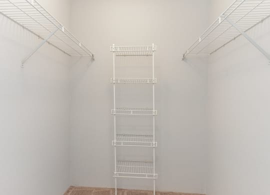 a white room with a ladder in the middle of it