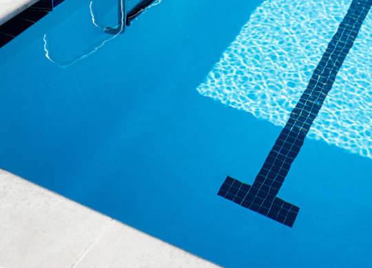 A swimming pool with a ladder on the side.
