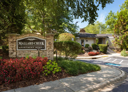 a home with a sign that says millard creek apartments