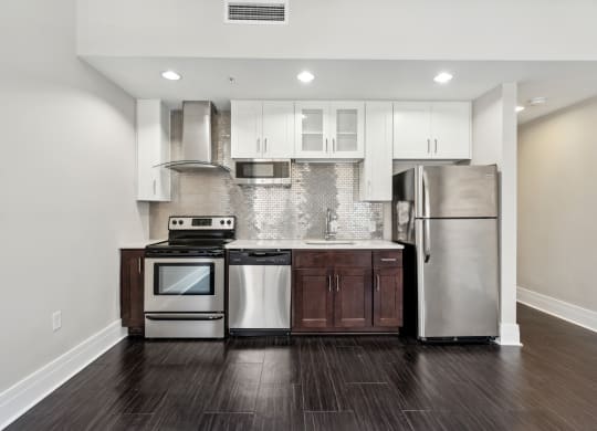 a kitchen with white cabinets and stainless steel appliances