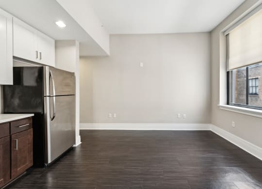 a kitchen with a refrigerator freezer next to a window