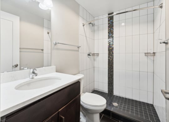 a bathroom with a toilet sink and shower