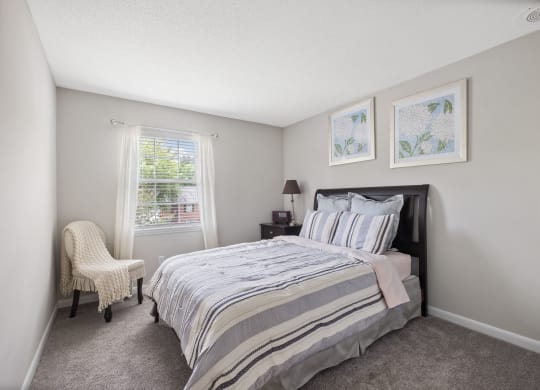 a bedroom with a bed and a chair