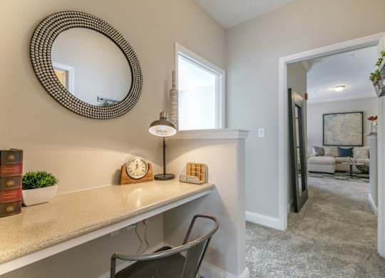 a home office with a desk and a mirror