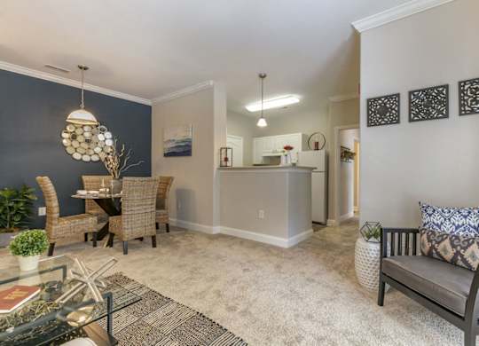 a living room and dining room with a table and chairs