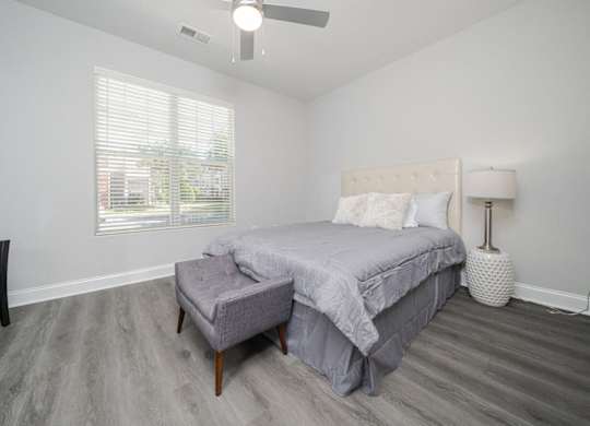 a bedroom with a bed and a ceiling fan