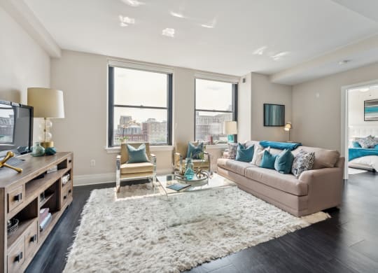 a living room with a couch chairs and a tv