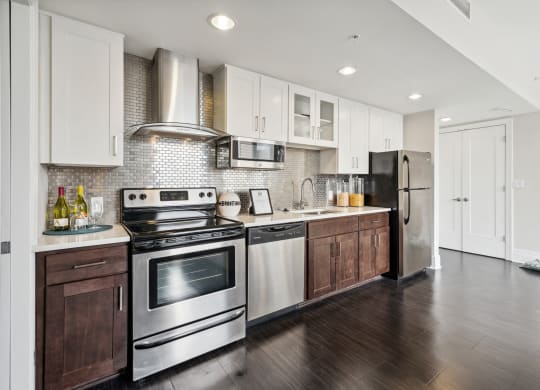 a kitchen with white cabinets and stainless steel appliances