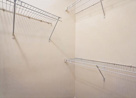 A white wall with a metal rack on it.