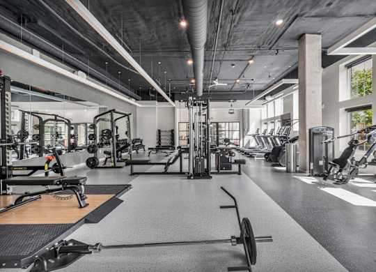 A spacious gym with a variety of equipment.