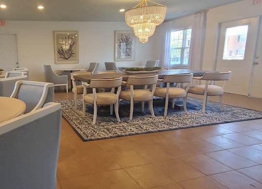 A dining room with a table and chairs.