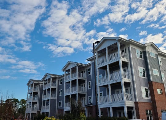 a row of apartment buildings with a blue sky in the background  at Barclay Place Apartments, Wilmington, NC, 28412
