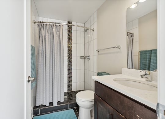 a bathroom with a toilet sink and shower