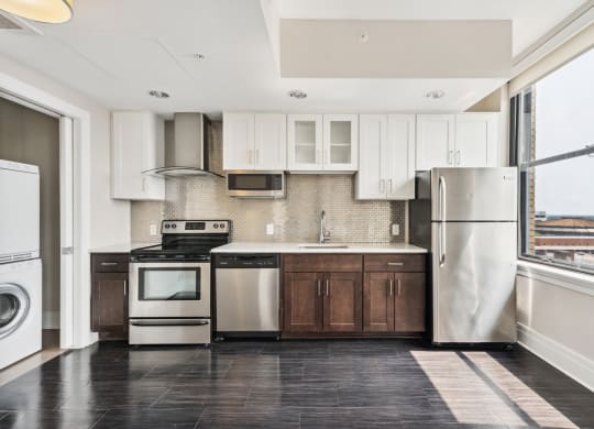 a kitchen with white cabinets and stainless steel appliances