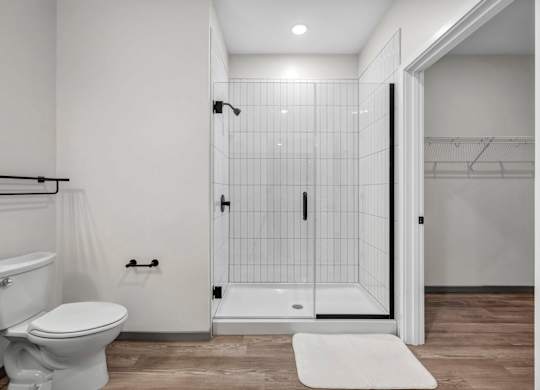 A white toilet and sink in a small bathroom.