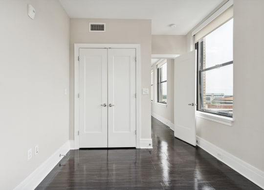 a bedroom with white walls and a black and white floor