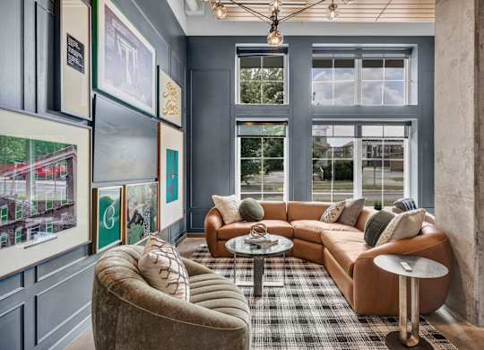 A living room with a brown couch, a grey armchair, and a coffee table.