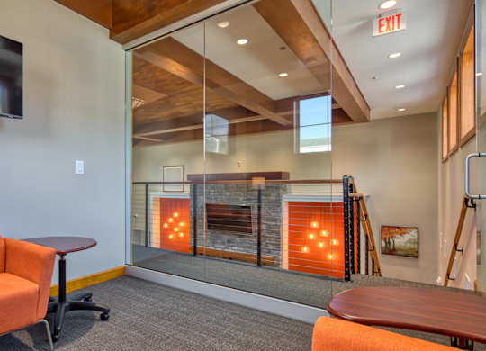 A room with a fireplace and a chair.