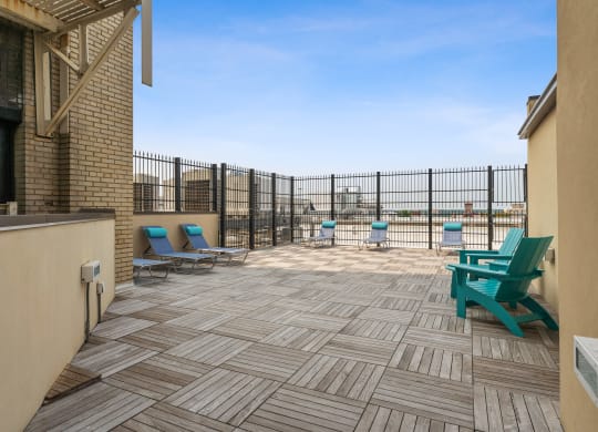 a patio with chairs and a grill at the villas at falling waters in west omaha