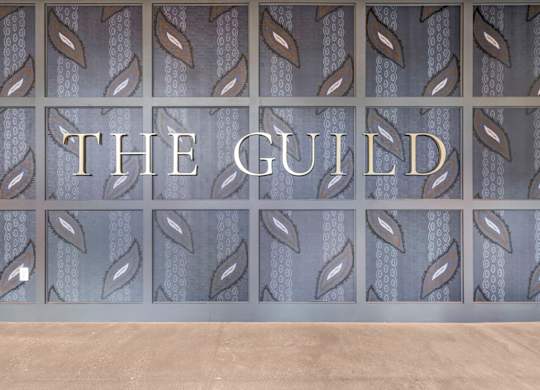 A wall with a pattern and the word