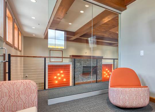 A modern living room with a fireplace and a chair.