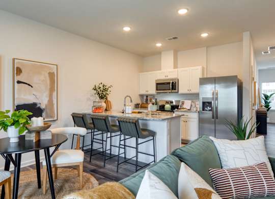 A modern kitchen with a dining table and chairs at The Mark Townhomes Apartments, Virginia, 22801