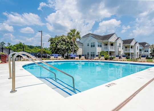 A swimming pool in front of a residential building.
