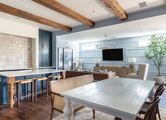 A modern kitchen with a dining table and chairs.