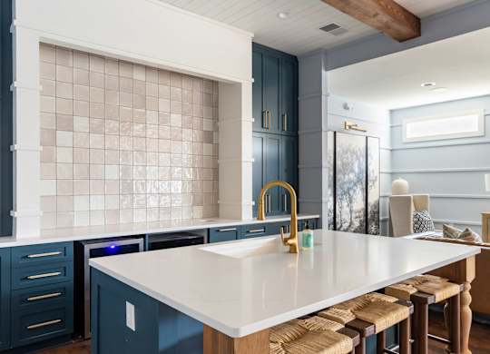 A kitchen with a white countertop and blue cabinets.