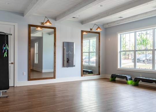 A room with a blackboard on the left and a mirror on the wall.