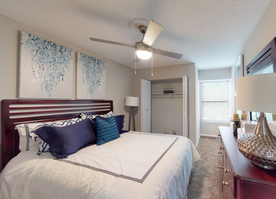 a bedroom with a large bed and a ceiling fan