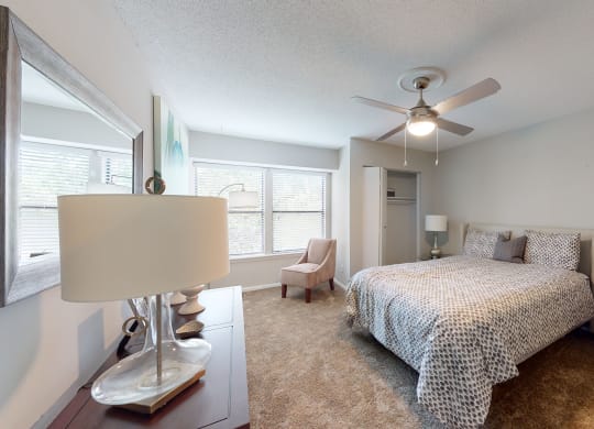 a bedroom with a bed and a ceiling fan