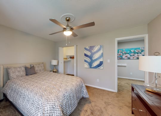 a bedroom with a bed and a ceiling fan