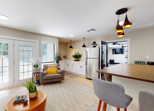 a kitchen and living room with a view of a pool
