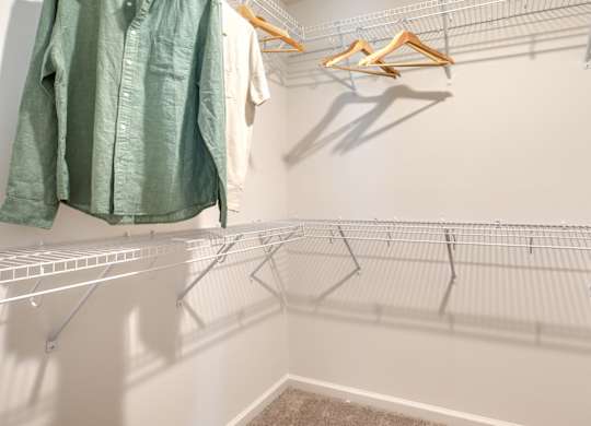 Clothes hanging on a rack in a room at The Mark Townhomes Apartments, Harrisonburg, VA