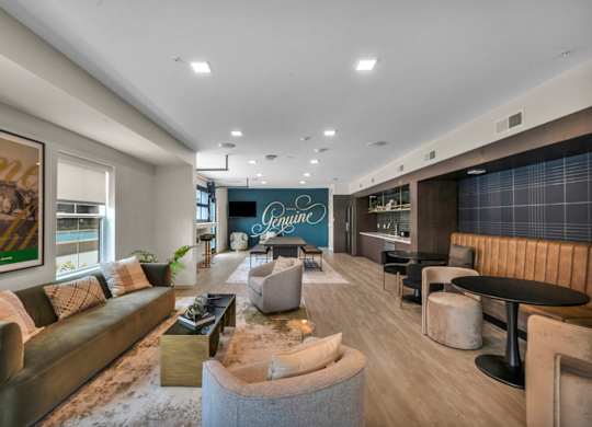 A modern living room with a large couch, a coffee table, and a fireplace.