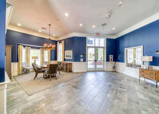 A spacious room with a dining table and chairs.