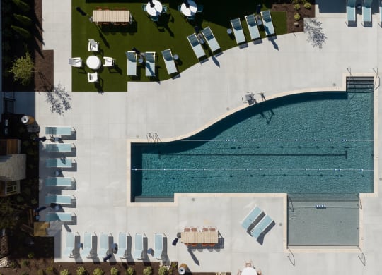 an aerial view of a swimming pool with umbrellas