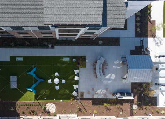 an aerial view of a yard with green grass and a fountain