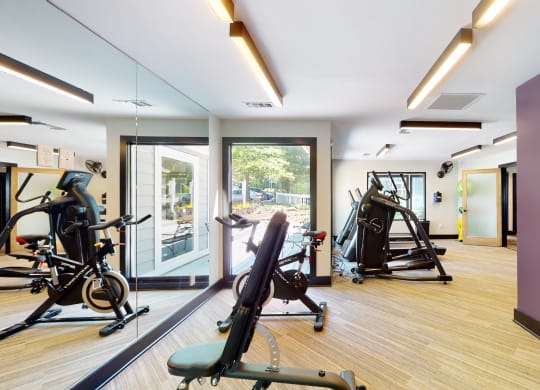 a gym with exercise equipment and a large window at Arbor Ridge, North Carolina, 27410