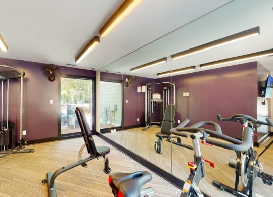 a home gym with exercise equipment and mirrors at Arbor Ridge, Greensboro, NC