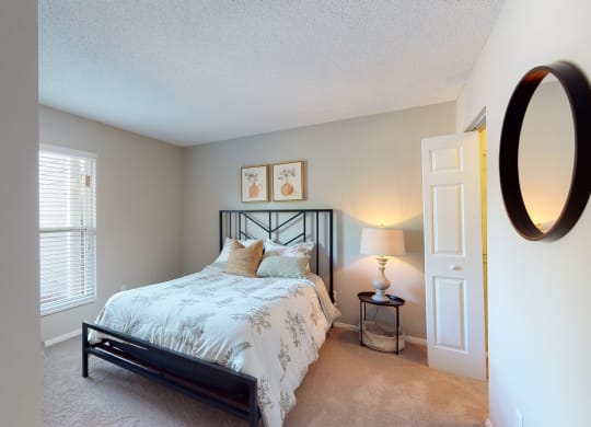 a bedroom with a bed and two windows  at Arbor Ridge, Greensboro, NC, 27410