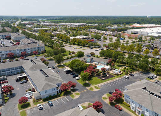 A bird's eye view of a parking lot surrounded by buildings.