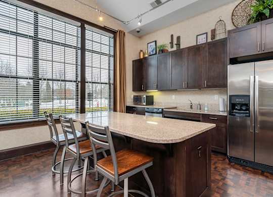 A kitchen with a table and chairs and a refrigerator.at Arlington Park, Hilliard, OH 43026
