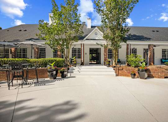 A large house with a driveway and a tree in front.
