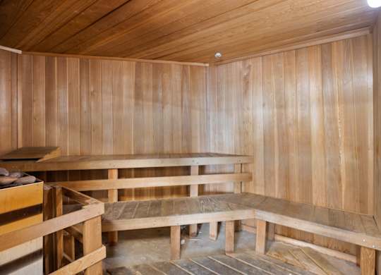 A wooden room with benches and a table.