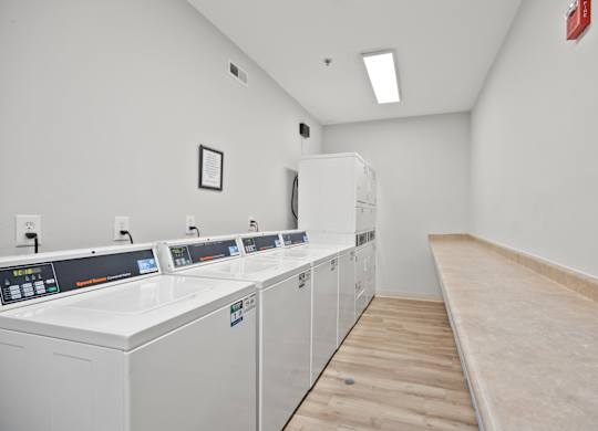 A laundry room with washers and dryers.