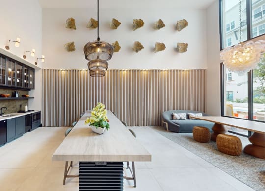 a dining room with a long wooden table and a kitchen