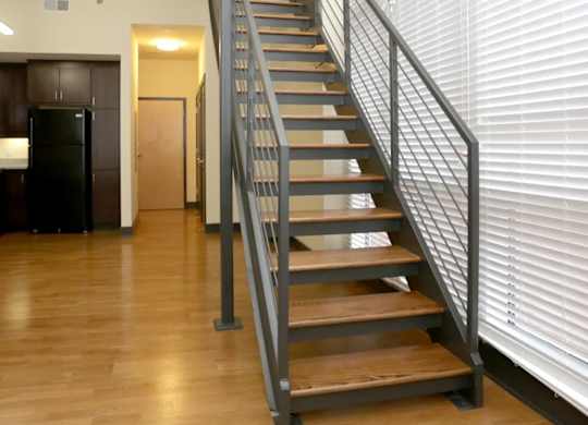 A staircase with wooden steps and metal railings.
