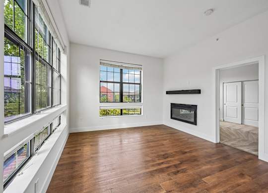 A room with a fireplace and a large window.